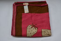 An as new Karen Mabon X Peter Rabbit woven raspberry blanket, part of a limited-edition capsule