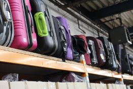 A quantity of pre-owned suitcases and holdalls.