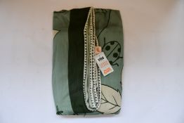 An as new Karen Mabon X Peter Rabbit woven green blanket, part of a limited-edition capsule