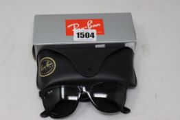 A pair of as new Ray Ban sunglasses.