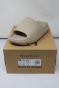 A pair of as new Adidas Yeezy Slide with authentication tag (UK 9).