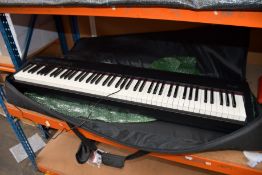 A pre-owned Roland FP-30 Digital Piano with case and pedal (Good condition).