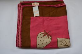 An as new Karen Mabon X Peter Rabbit woven raspberry blanket, part of a limited-edition capsule