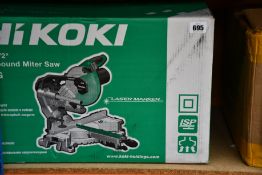 A boxed as new Hikoki C8FSHG slide compound mitre saw.