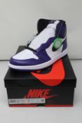 A pair of as new Nike Air Jordan 1 Retro High OG purple (UK 7).
