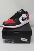 A pair of as new Nike Air Jordan 1 Low with authentication tag (UK 9.5).