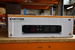 A boxed as new Behringer KM1700 professional stereo power amplifier.