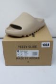 A pair of as new Adidas Yeezy Slide with authentication tag (UK 10).
