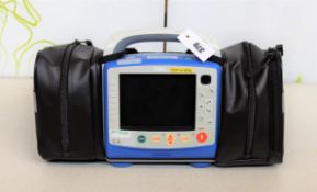 A pre-owned ZOLL X Series Monitor Defibrillator with Zoll SurePower II Lithium Ion Battery, Charger,