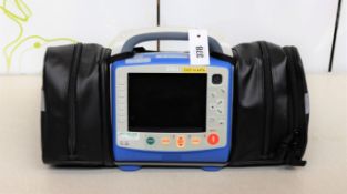 A pre-owned ZOLL X Series Monitor Defibrillator with Zoll SurePower II Lithium Ion Battery, Charger,