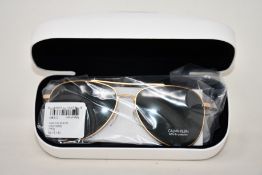 A pair of as new Calvin Klein sunglasses.