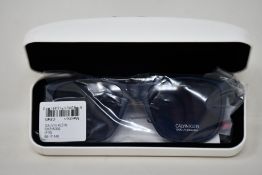 A pair of as new Calvin Klein sunglasses.
