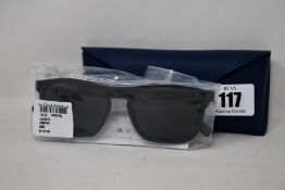 A pair of as new Lacoste sunglasses.