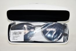 A pair of as new Calvin Klein sunglasses.