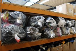 Twelve bags of assorted clothing and related items.