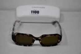 A pair of as new Calvin Klein sunglasses.