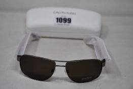 A pair of as new Calvin Klein sunglasses.