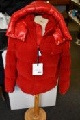 An as new Moncler Vignemale coat in red (M).