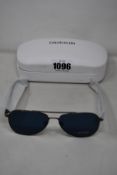 A pair of as new Calvin Klein sunglasses.