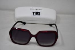 A pair of as new Calvin Klein sunglasses.