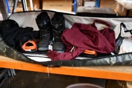 A Dakine Low Roller 185 snowboard bag containing pre-owned winter sports equipment to include a Ride