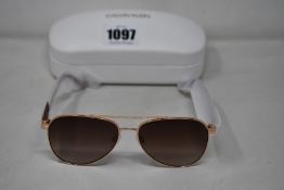 A pair of as new Calvin Klein sunglasses.