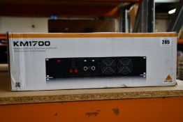A boxed as new Behringer KM1700 professional stereo power amplifier.