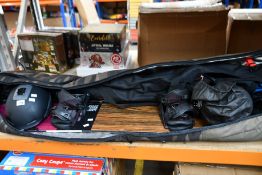 A Dakine Low Roller 165 snowboard bag containing pre-owned winter sports equipment and clothing (