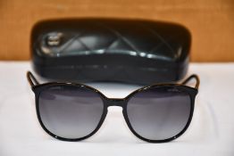 A pair of as new Chanel sunglasses.