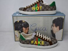 A pair of men's as new Gucci Ace Not Fake sneakers (Size 6 - RRP £465).