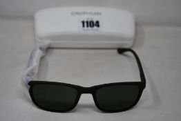 A pair of as new Calvin Klein sunglasses.
