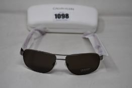 A pair of as new Calvin Klein sunglasses.