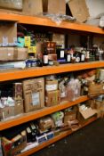 Three shelves of assorted food items to include olive oil, confectionery, assorted teas/coffee,