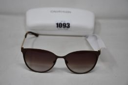 A pair of as new Calvin Klein sunglasses.