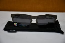 A pair of as new Oakley Holston sunglasses.