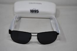 A pair of as new Calvin Klein sunglasses.