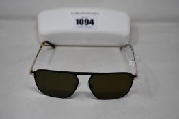 A pair of as new Calvin Klein sunglasses.