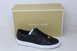 A pair of as new Michael Kors Keaton lace up sneakers (US 7.5M).
