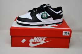A pair of as new Nike Dunk Low Retro with authentication tag (UK 10).