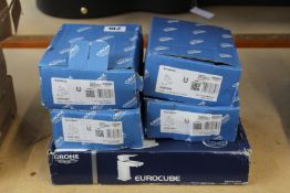 Four as new Grohe 23051002 Eurodisc pillar taps and an as new Grohe 23823000 Eurocube bathroom mixer