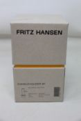Four boxed as new Fritz Hansen solid brass candle holders (H 10.5cm).