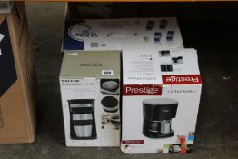 A boxed Salter coffee maker 'to go', a Prestige coffee maker and a Meseta coffee capsules system.