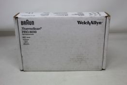 A boxed as new Braun welch allyn ThermoScan PRO 6000 with cradle.