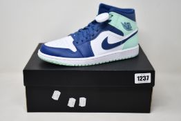 A pair of as new Nike Air Jordan 1 Mid with authentication tag (UK 7).