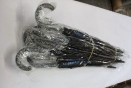 Twelve black walking stick umbrellas with car brand motif.