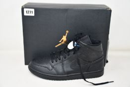 A pair of pre-owned Air Jordan 1 mid with authentication tag (UK 9).