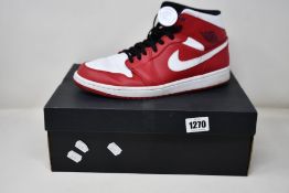 A pair of pre-owned Nike Air Jordan 1 Mid with authentication tag (UK 11 - Good condition).