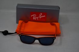 A pair of as new Ray Ban sunglasses.