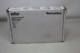 A boxed as new Braun welch allyn ThermoScan PRO 6000 with cradle.