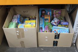 Two boxes of as new toys and games to include Lego, pool floats, Game of Thrones board game,